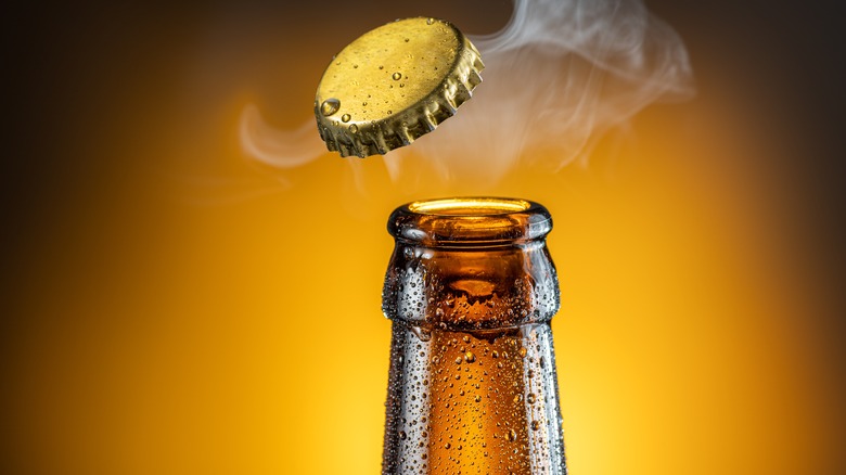 Beer bottle neck with cap floating in the air