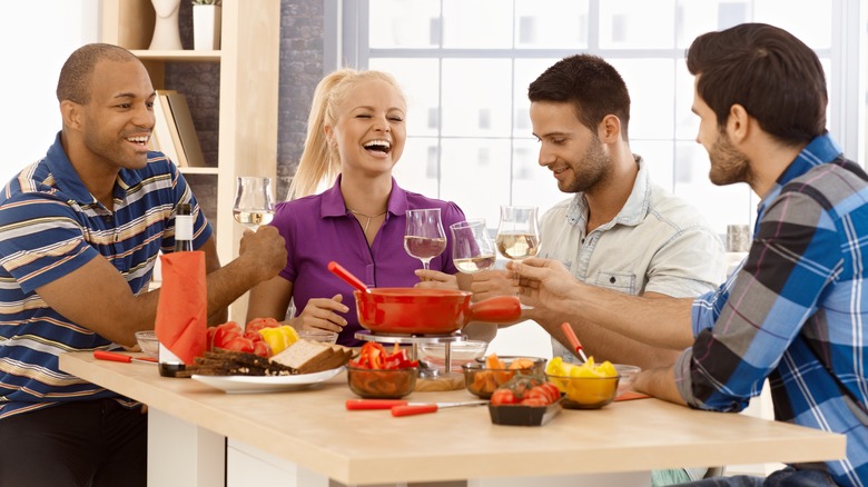 friends enjoying fondue spread