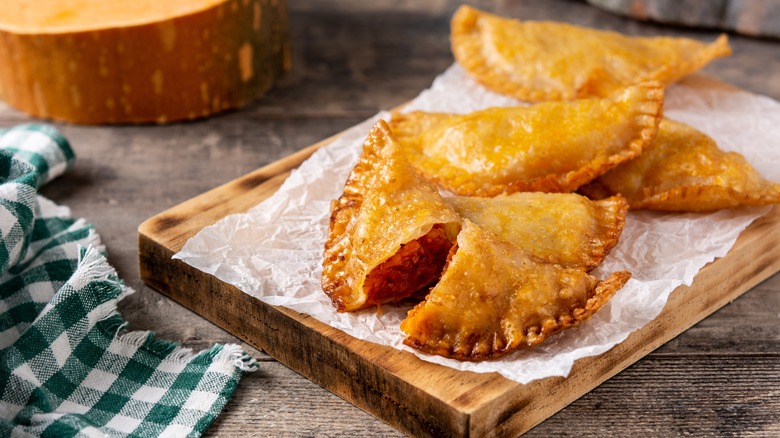 Empanadillas on wooden board