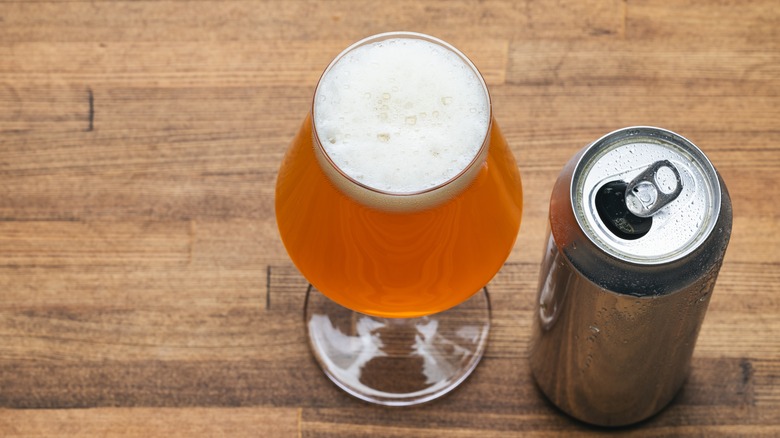 beer in tulip glass next to beer can