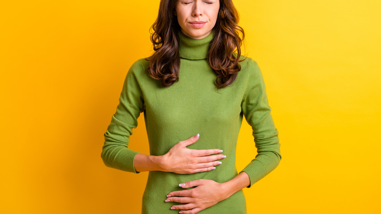 Woman holding stomach