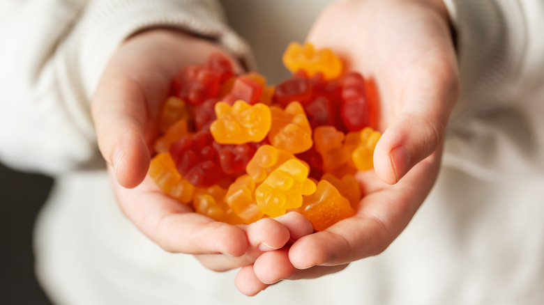 child holding gummy bears