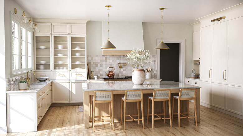 Bright kitchen with a four-stool island, wood floor, off-white cabinets, and multitone backsplash