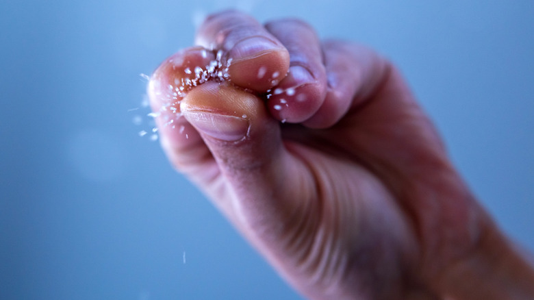 hand sprinkling salt