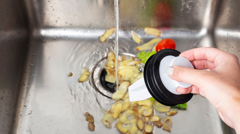 Person holding a sink tamper