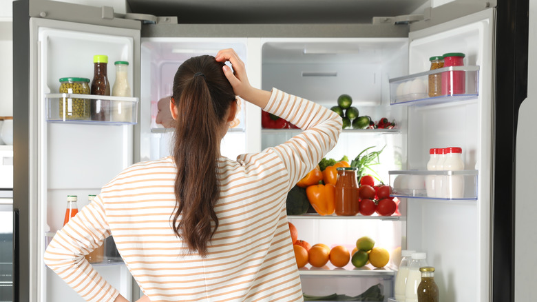 woman looking into fridge