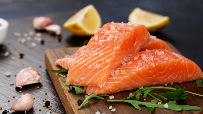 Raw salmon on cutting board