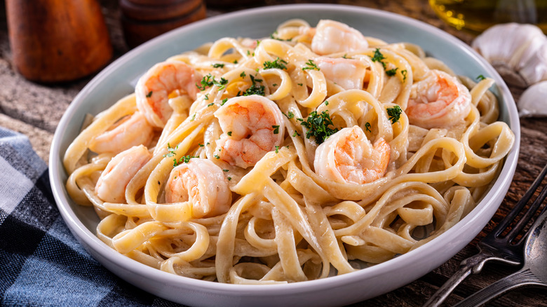 Shrimp alfredo on fully set table