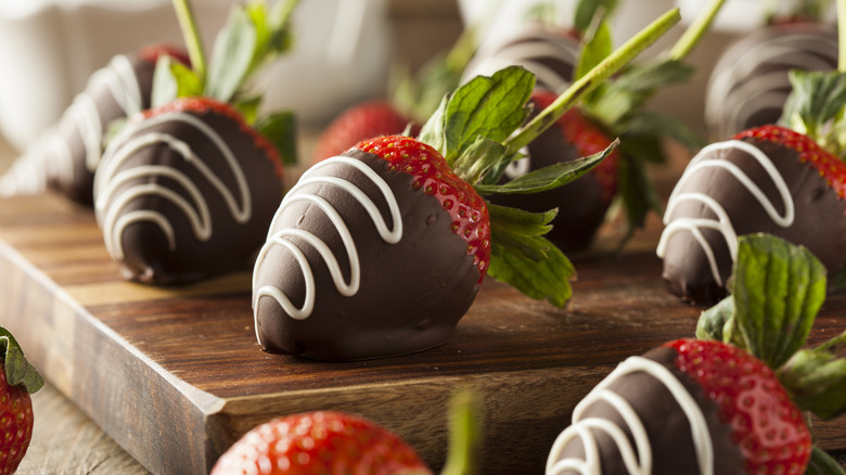 homemade chocolate covered strawberries on a wood block