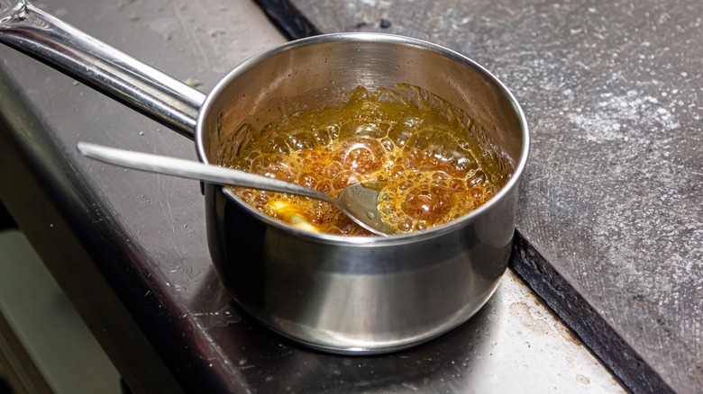 Metal spoon in melting sugar