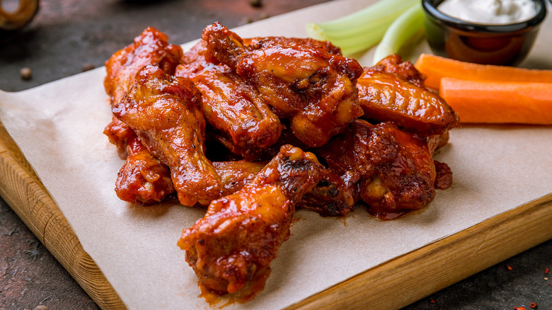 hot wings and vegetables on a board