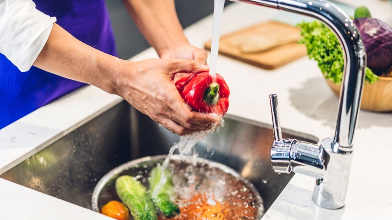 washing pepper over sink