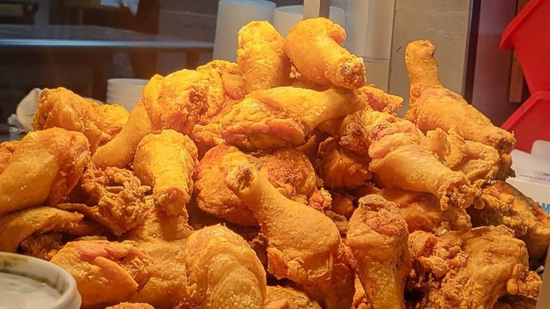 A pile of crispy fried chicken drumsticks from Yogi Bear Honey Fried Chicken