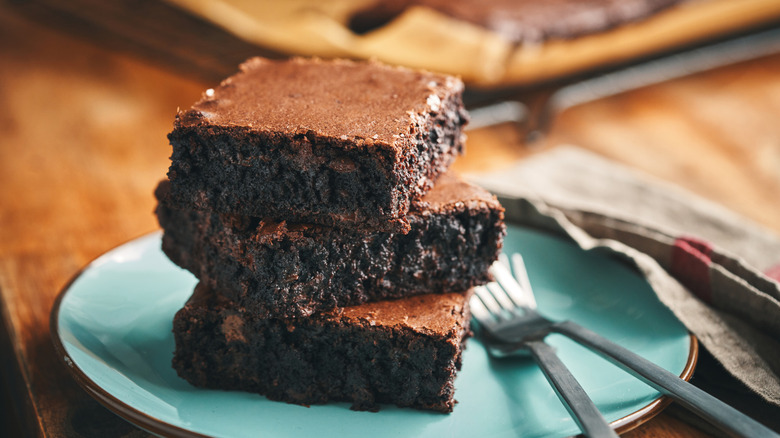 fudgy homemade brownies stacked on a rustic plate