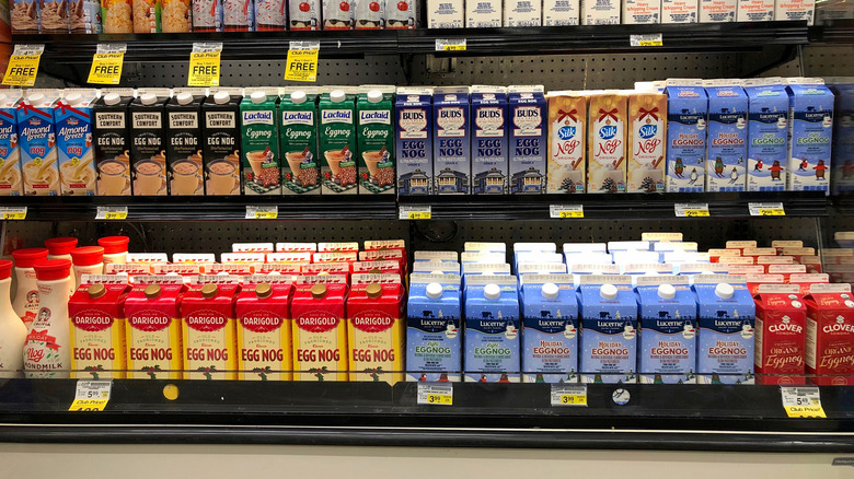Various brands of eggnog in a store refrigeration display unit