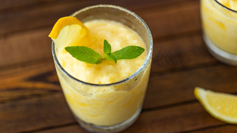 Glass of frozen lemonade with sprig of mint