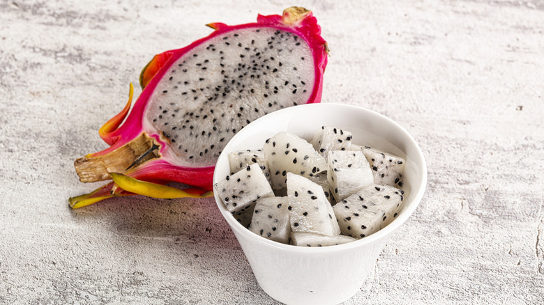 Halved dragon fruit, with bowl of dragon fruit cubes
