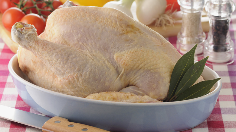 An uncooked chicken 