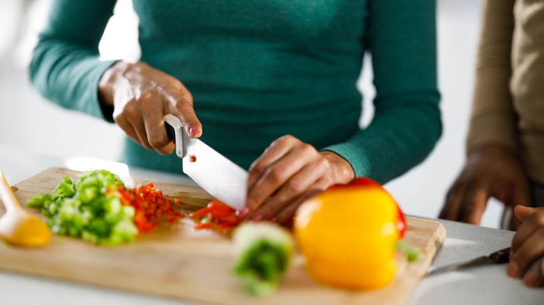 Person slicing bell peppers