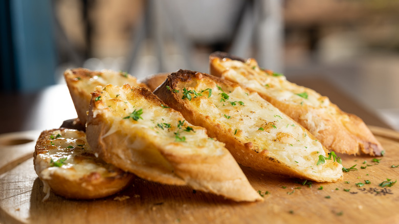 Garlic bread slices on cutting board