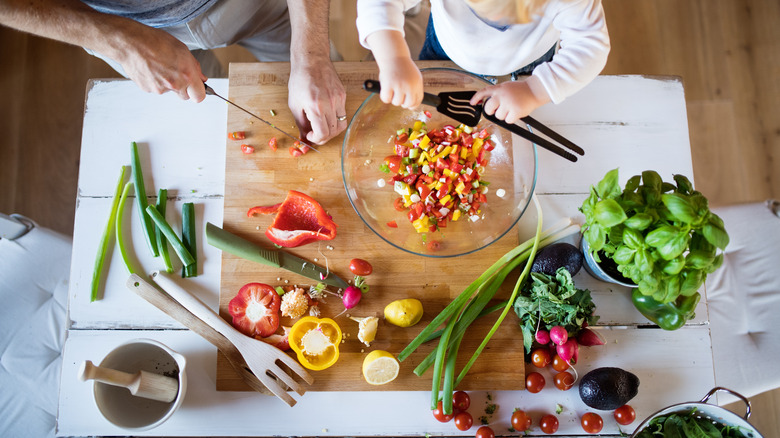 Preparation of vegetables on a wooden cutting board
