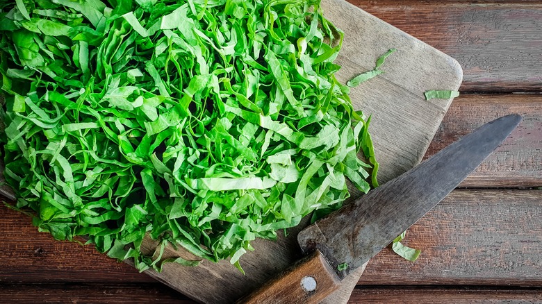 finely sliced lettuce on cutting board