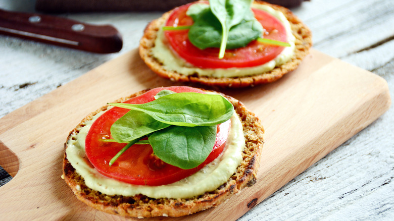 Open-face tomato and spinach sandwich on English muffin