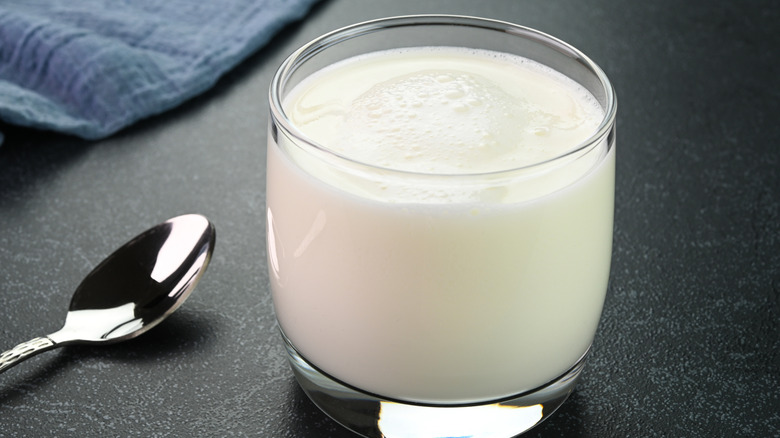 Glass of buttermilk with spoon