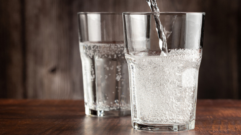 Soda water pouring into glass