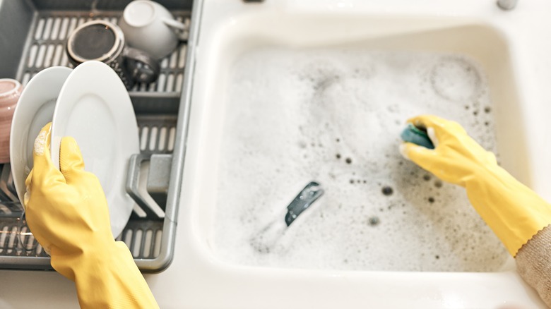 A person cleans with soapy water