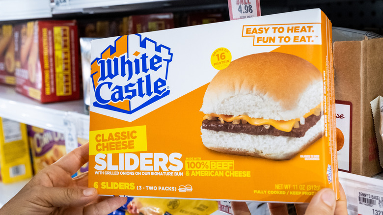 Person holding a box of White Castle Frozen Sliders