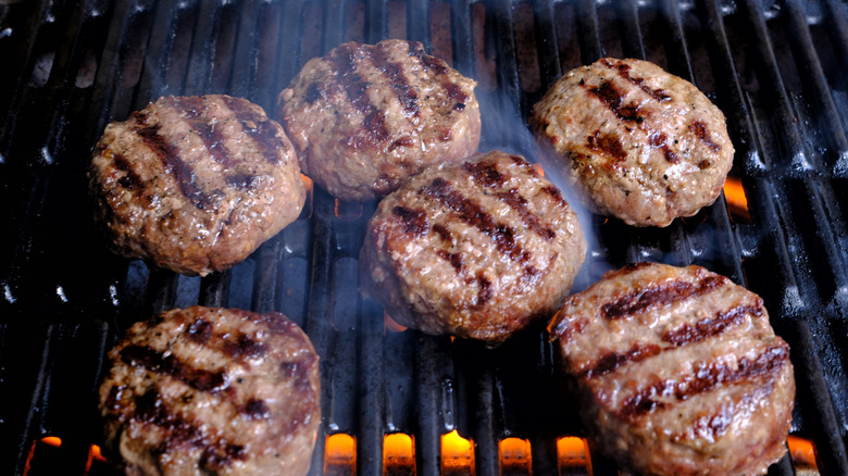 Slider burgers cooking on a grill