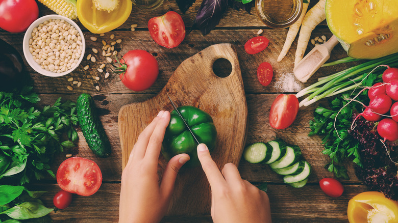 Hands chopping bell pepper