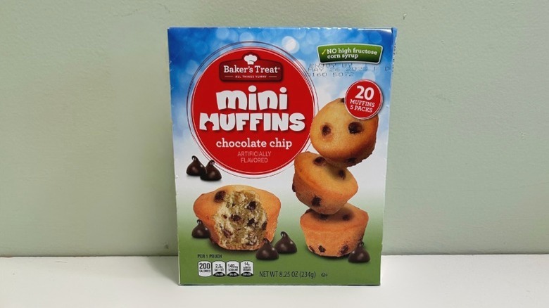A box of mini muffins on a green and white background