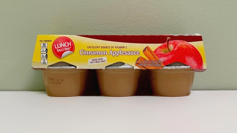 A pack of Lunch Buddies Cinnamon Applesauce on a green and white background