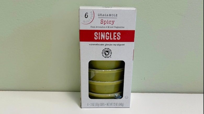 A pack of Guacamole Singles on a green and white background
