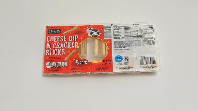 A pack of Savoritz Cheese Dip and Cracker Sticks on a green and white background