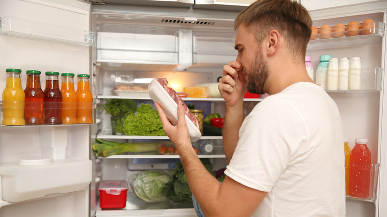 man with smelly meat in fridge