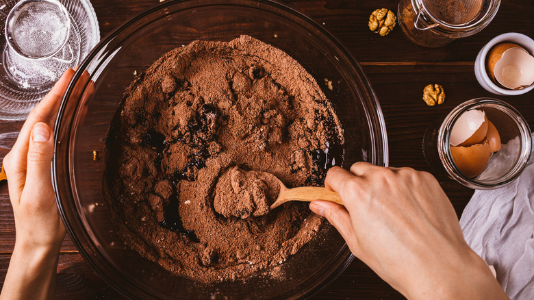 mixing together brownie batter with whisk